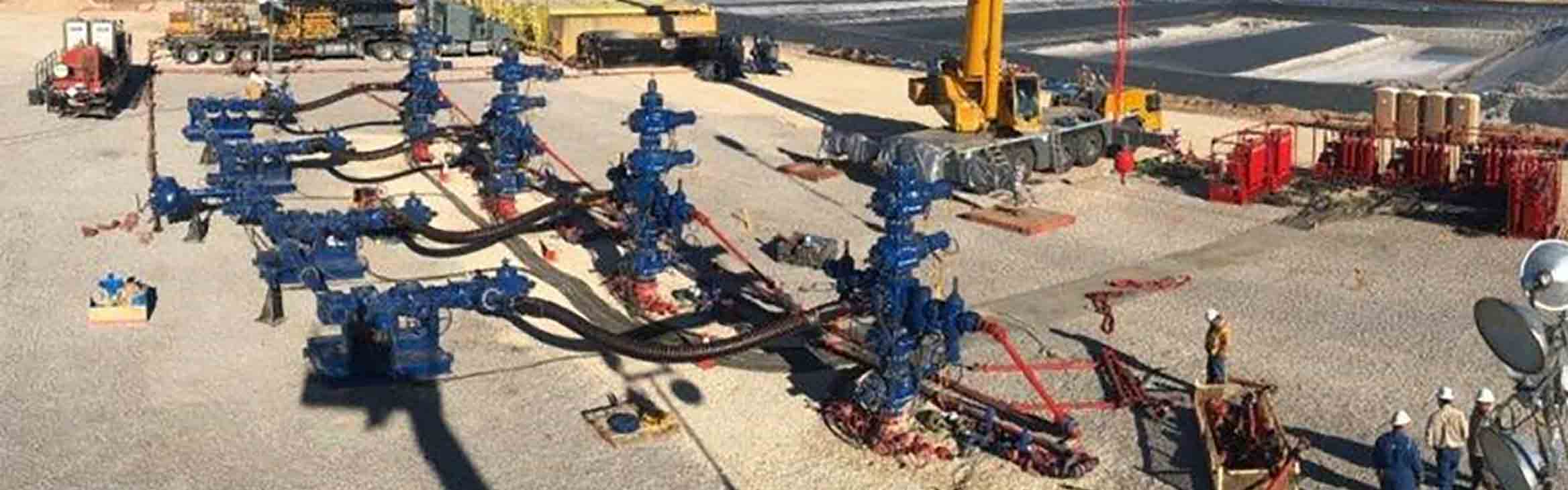 Photo of four wellheads fitted with MonoFlex fracturing fluid delivery technology. 