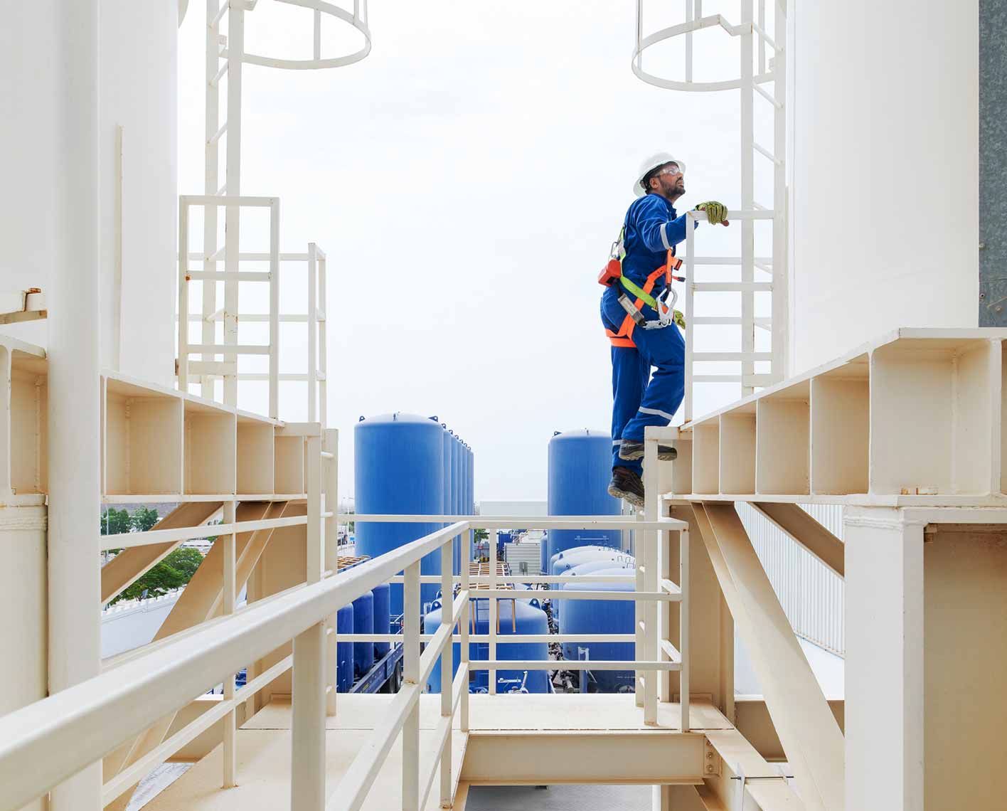 An SLB operator in blue coveralls and safety equipment