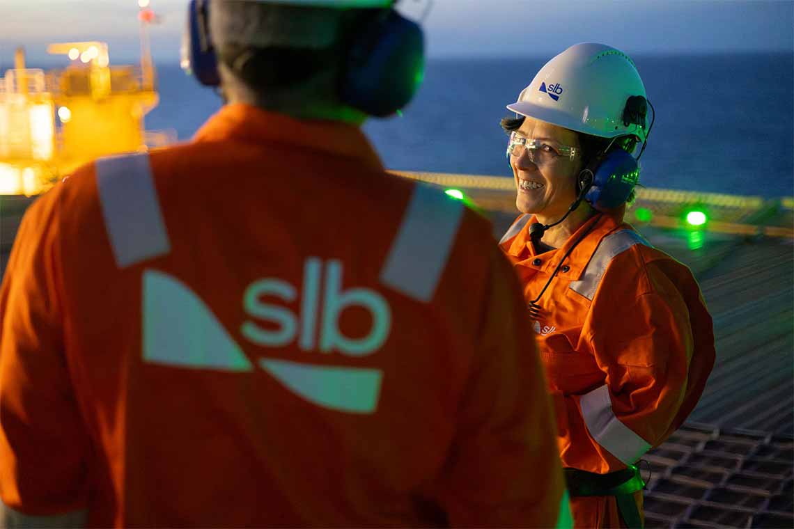 Two offshore SLB operators wearing proper PPE