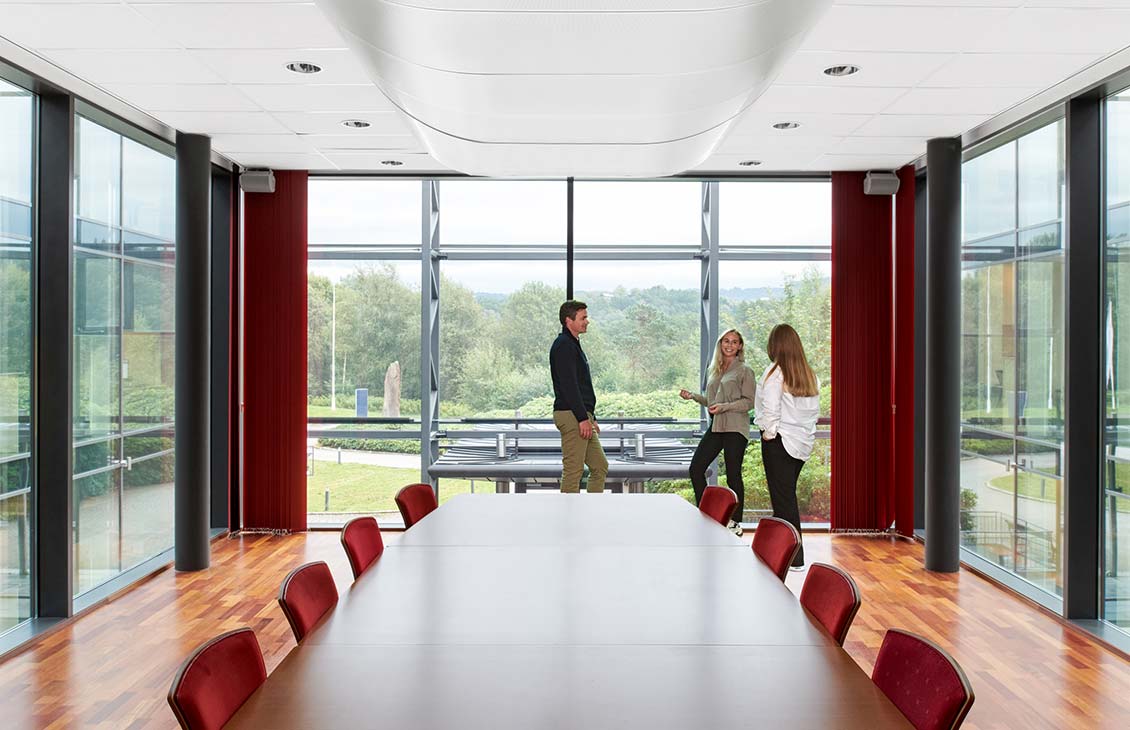 Three people in a conference room