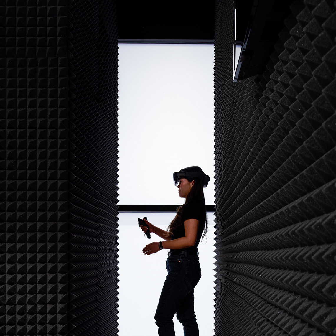 woman with a VR headset on and a remote in her hand