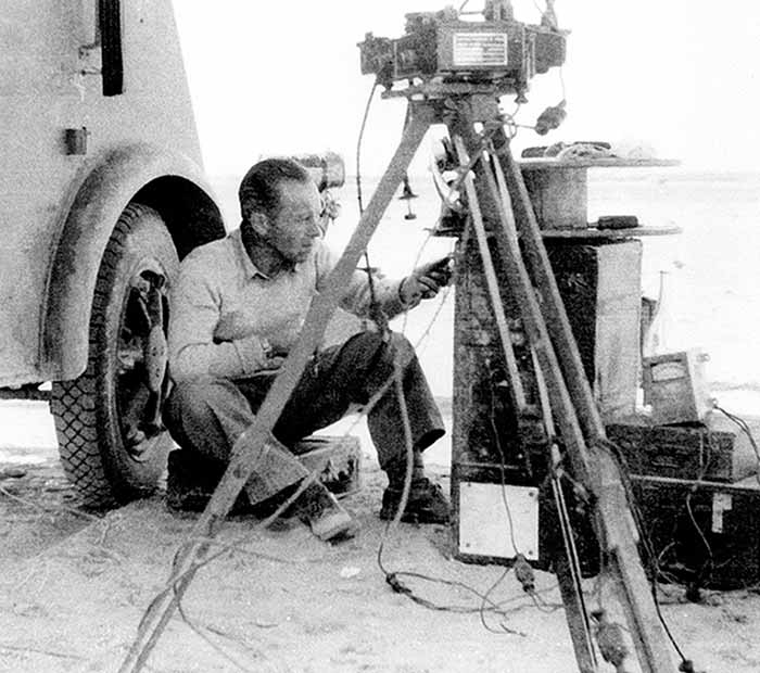 An engineer in Tunisia 1946, preparing recorder equipment and panels (connected to the cable and logging tool down in the hole).