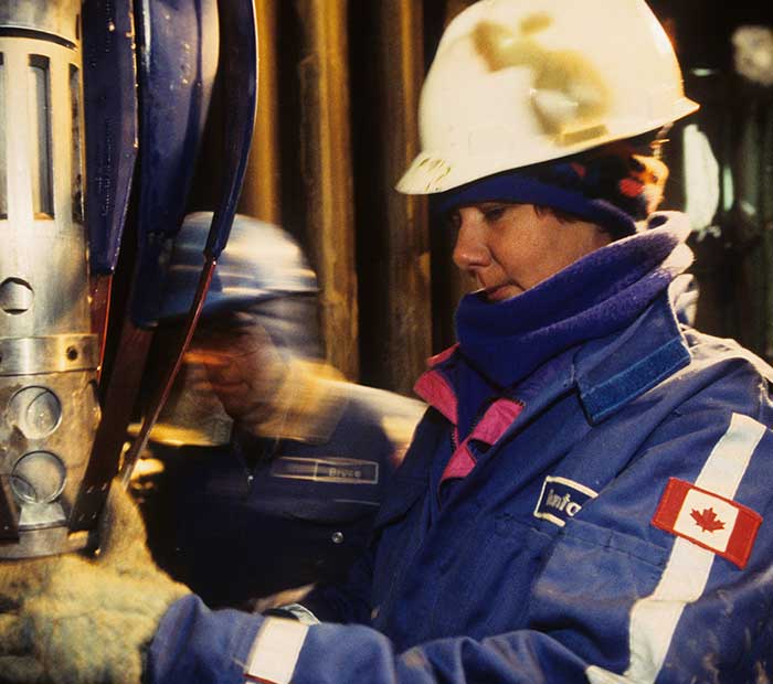 Two Canadian operators inspecting a drilling tool