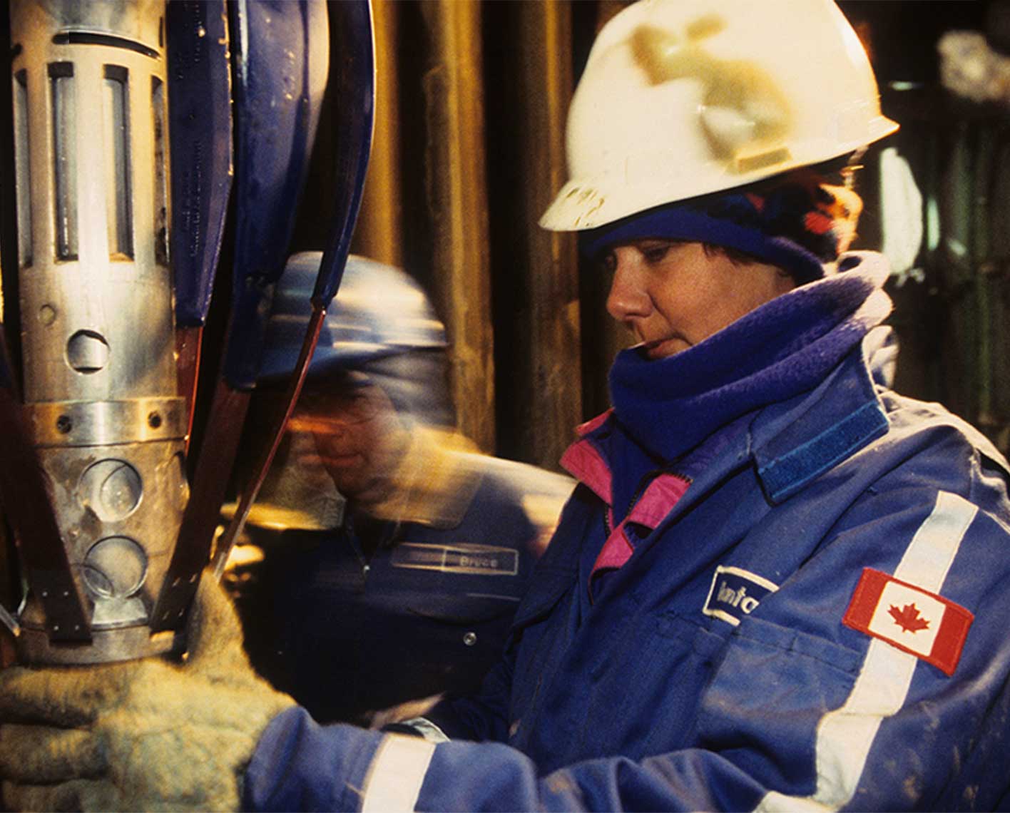 Two Canadian operators inspecting a drilling tool