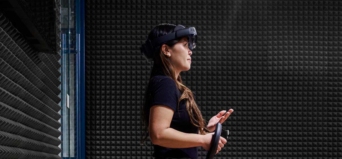 Woman with a VR headset on in a noise proof room