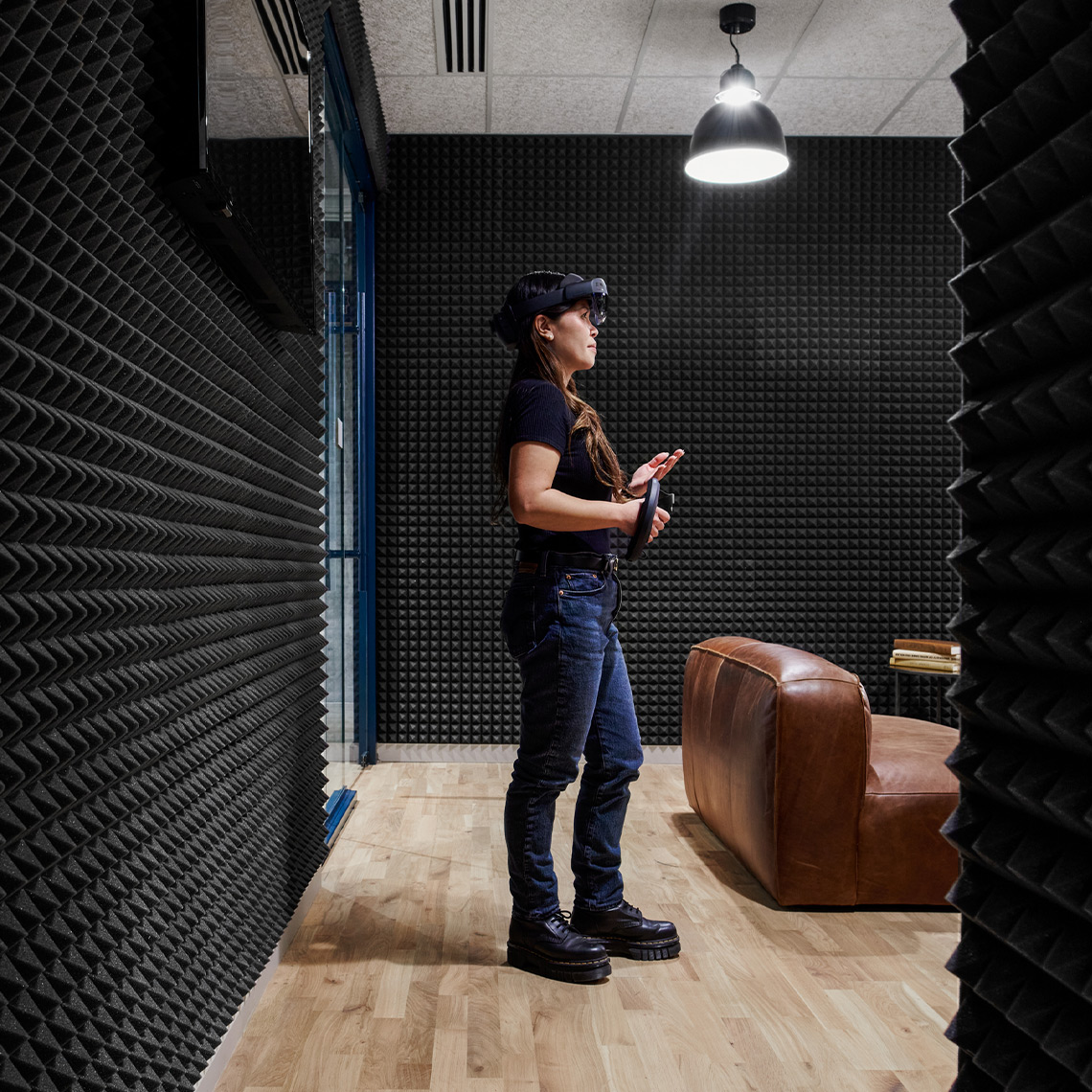 Woman with a VR headset on in a noise proof room