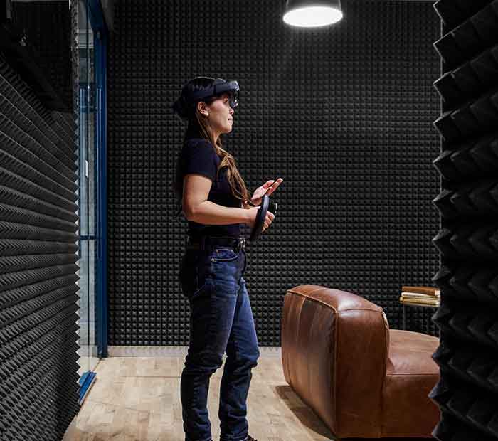 Woman with a VR headset on in a noise proof room
