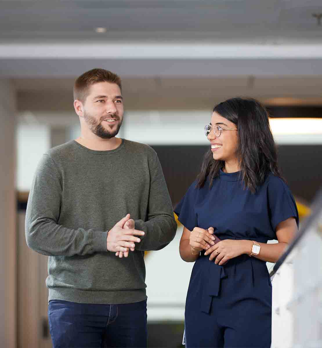 Workers collaborate in an office setting.