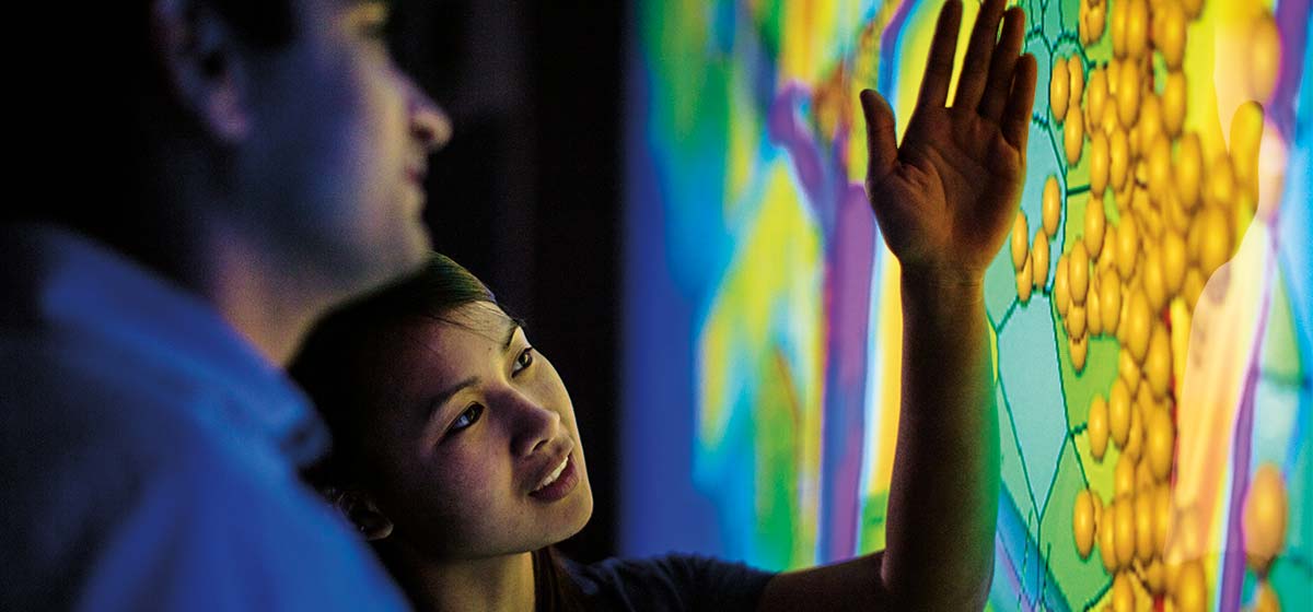 two people review seismic data using E&P software