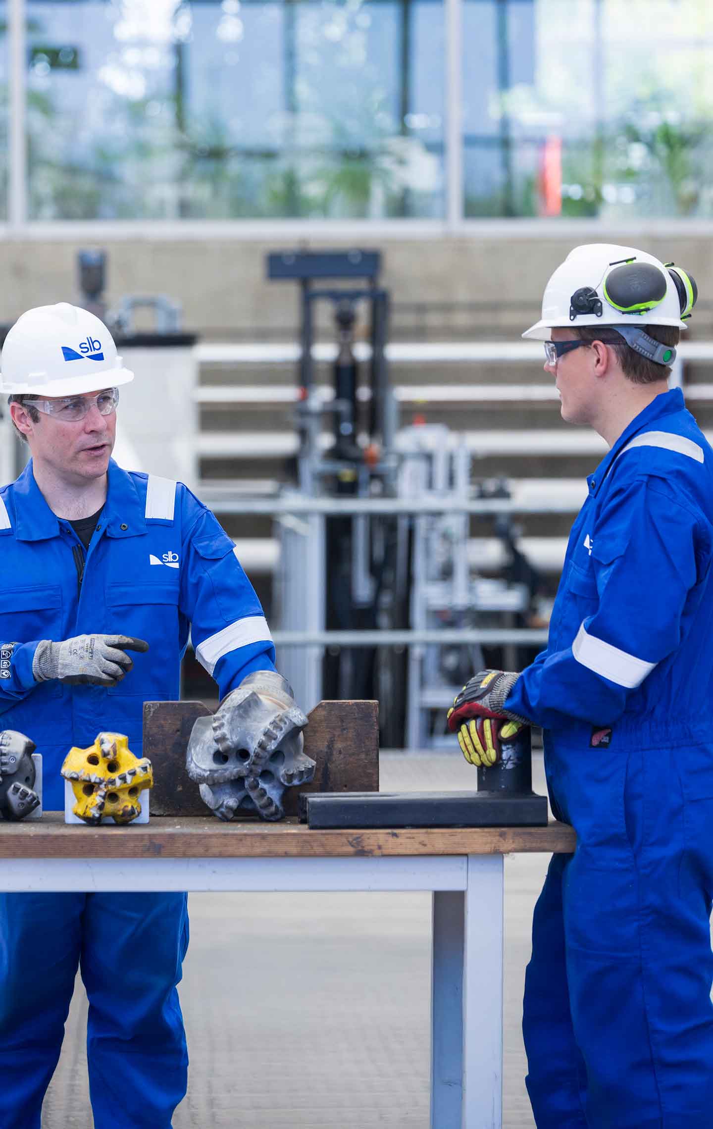 Two SLB employee having a conversation in a facility warehouse
