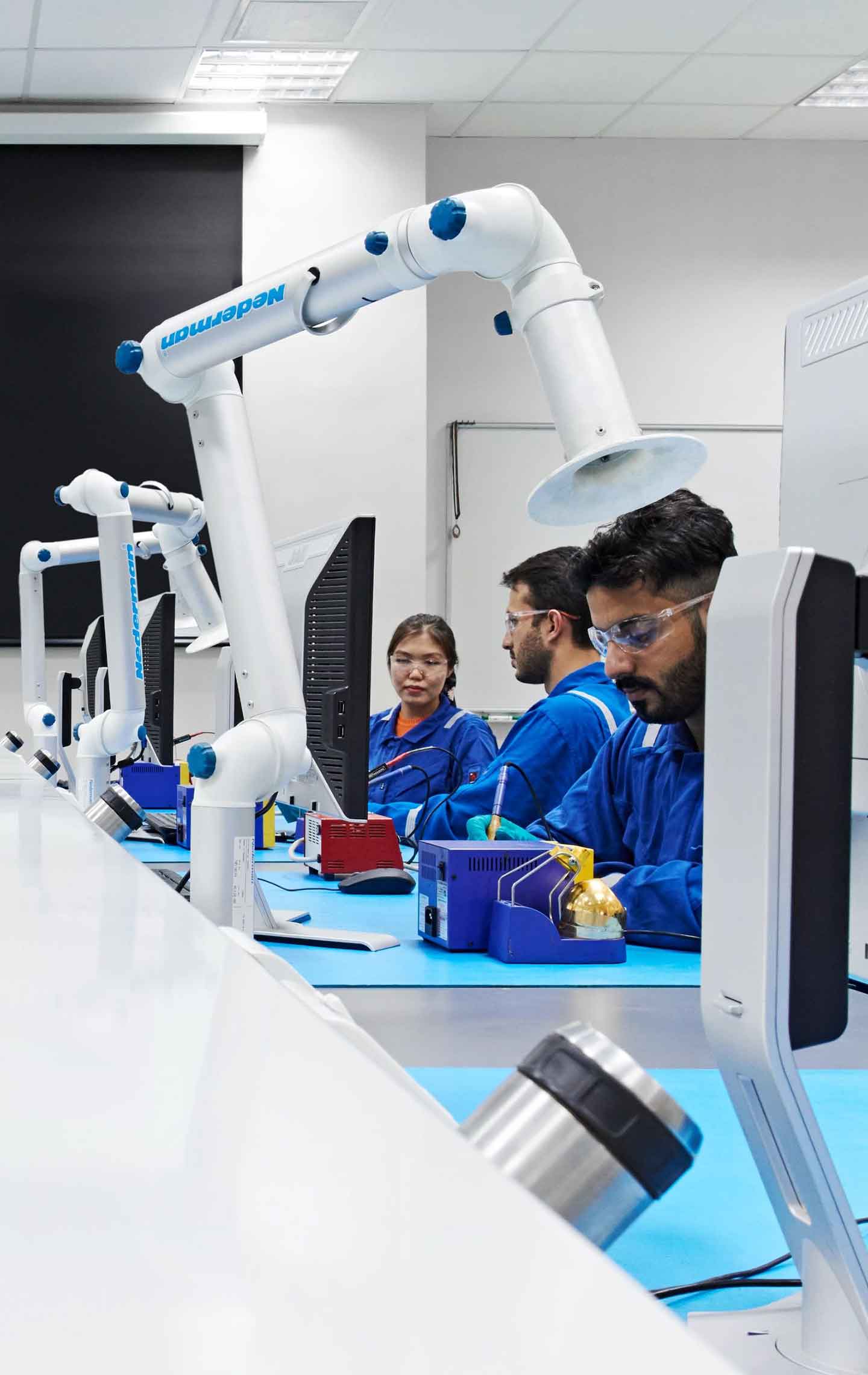 A group of SLB employees in front of monitors and equipment