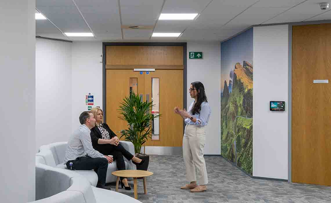 Photo of people chatting in a gathering area in the facility