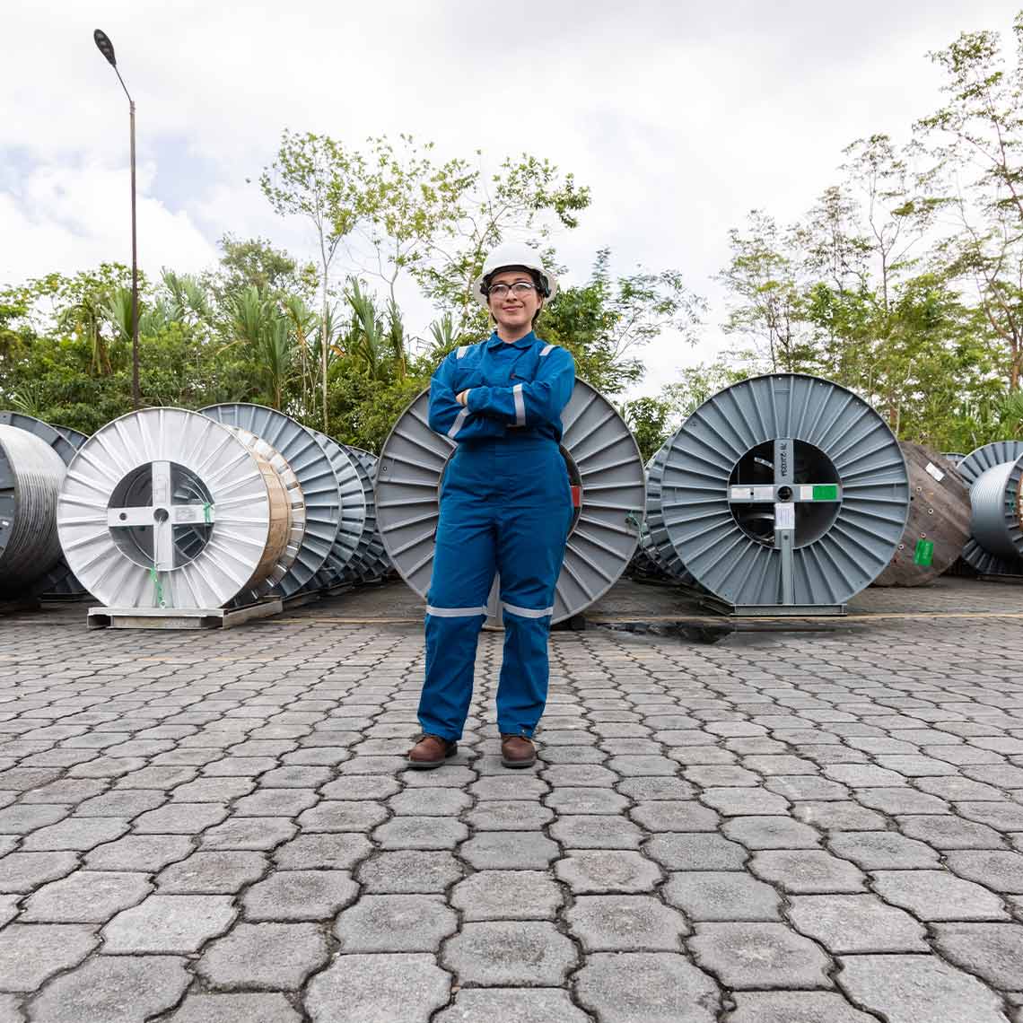 SLB employee standing in front of three spindles