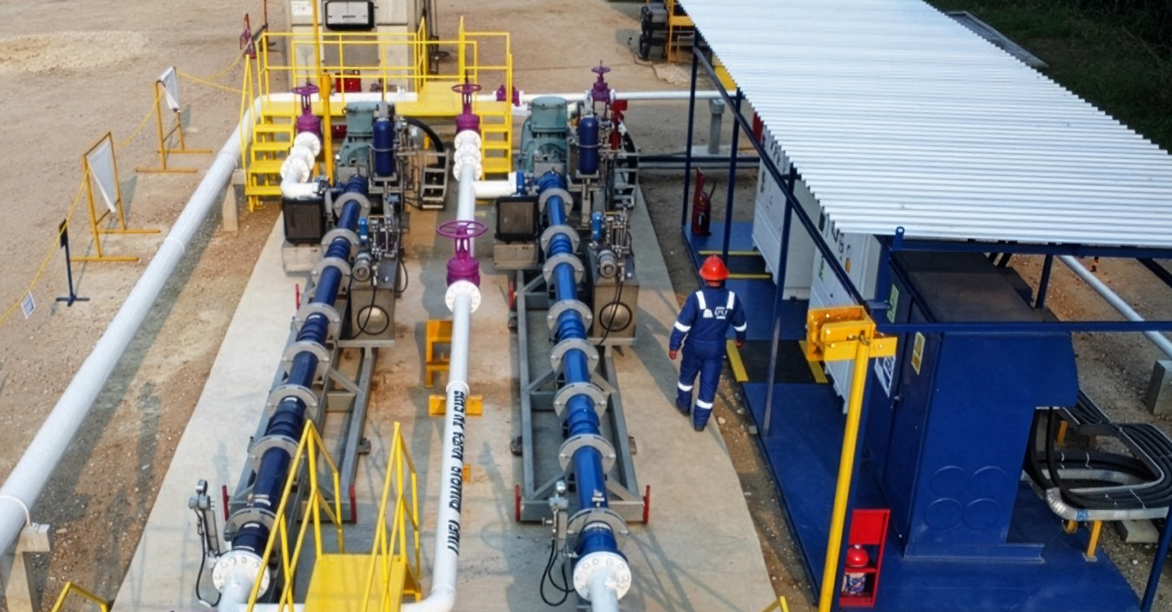 Aerial photo of two Reda Multiphase HPS horizontal multistage surface pumps at the well pad.