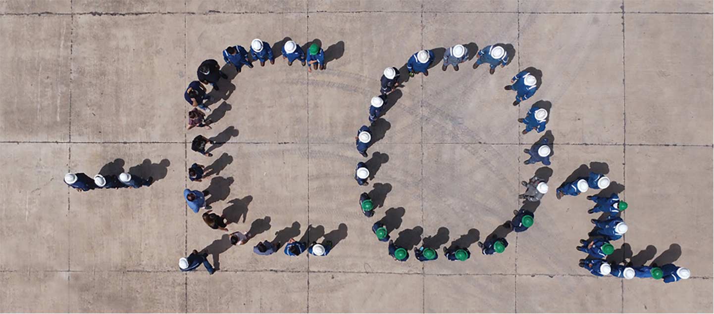 Overhead photo of people standing together to form the text CO2.
