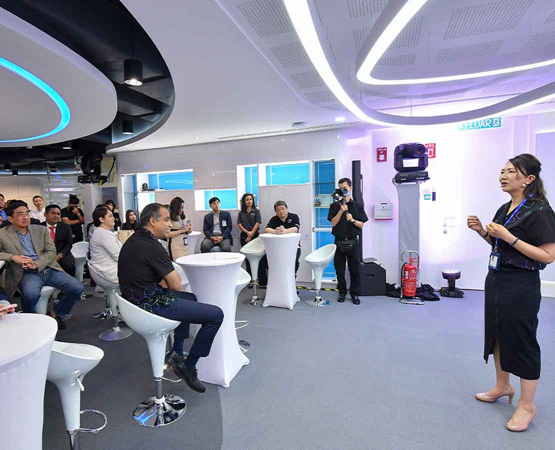 Woman speaking to room of people