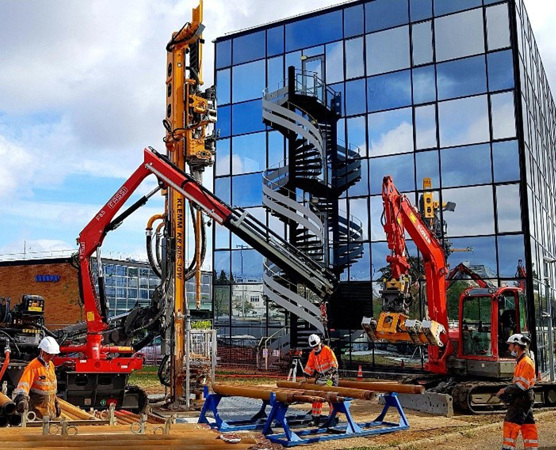 Drilling rig in front of building