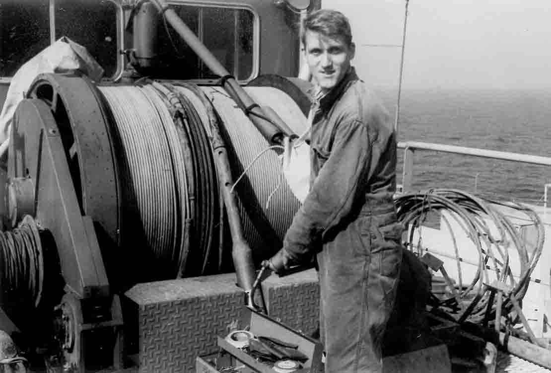 Black and white photo of man in wireline truck.