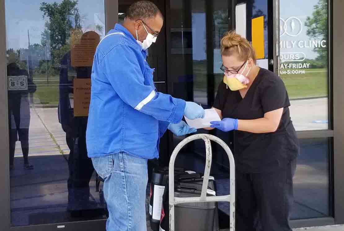 Healthcare clinic receiving hand sanitizer made by the Schlumberger facility in Louisiana.