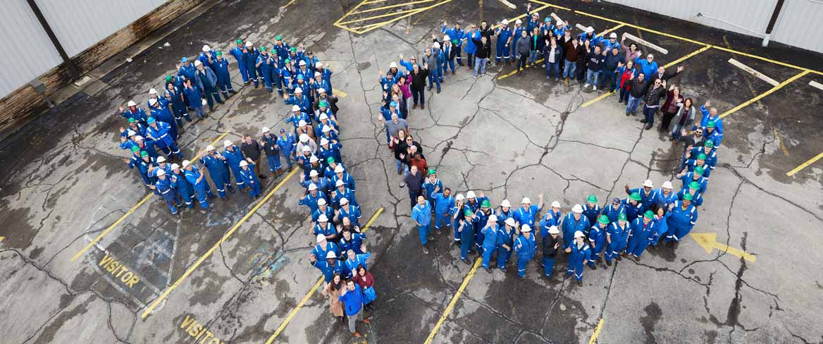 Schlumberger employees lined up to spell "90" outside the REDA facility.