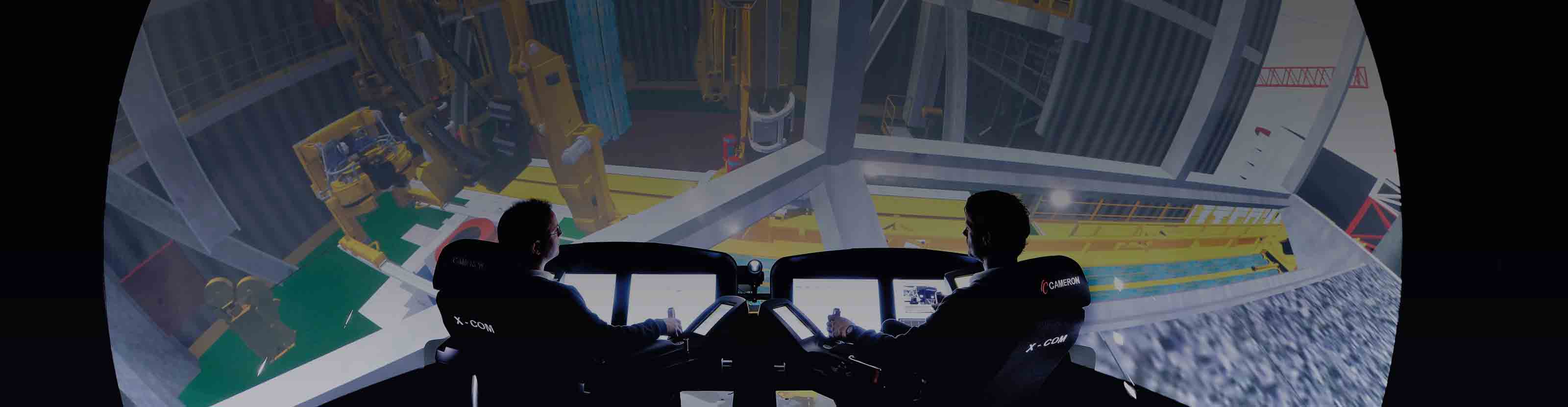 Workers monitoring rig equipment in onsite control room.