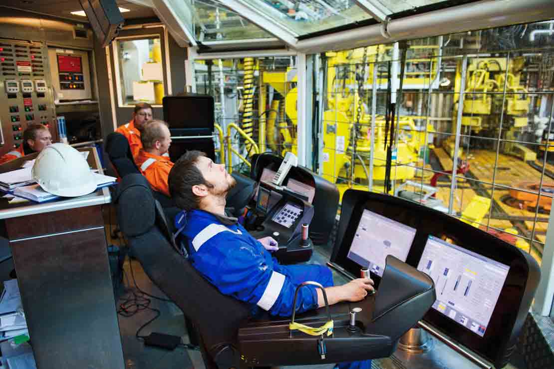 Inside of the drilling control room with operators sitting in the x-com chair