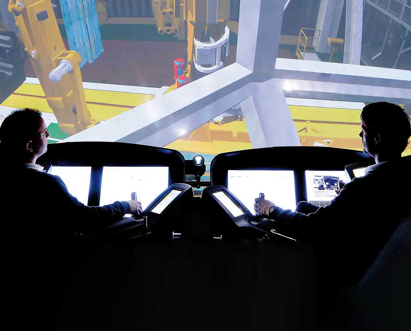 Two men in drilling chairs simulating drilling operation.