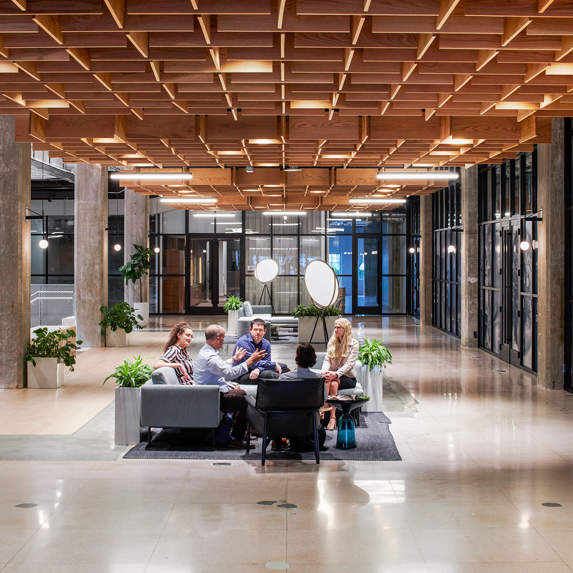 group of SLB employees meeting on couches