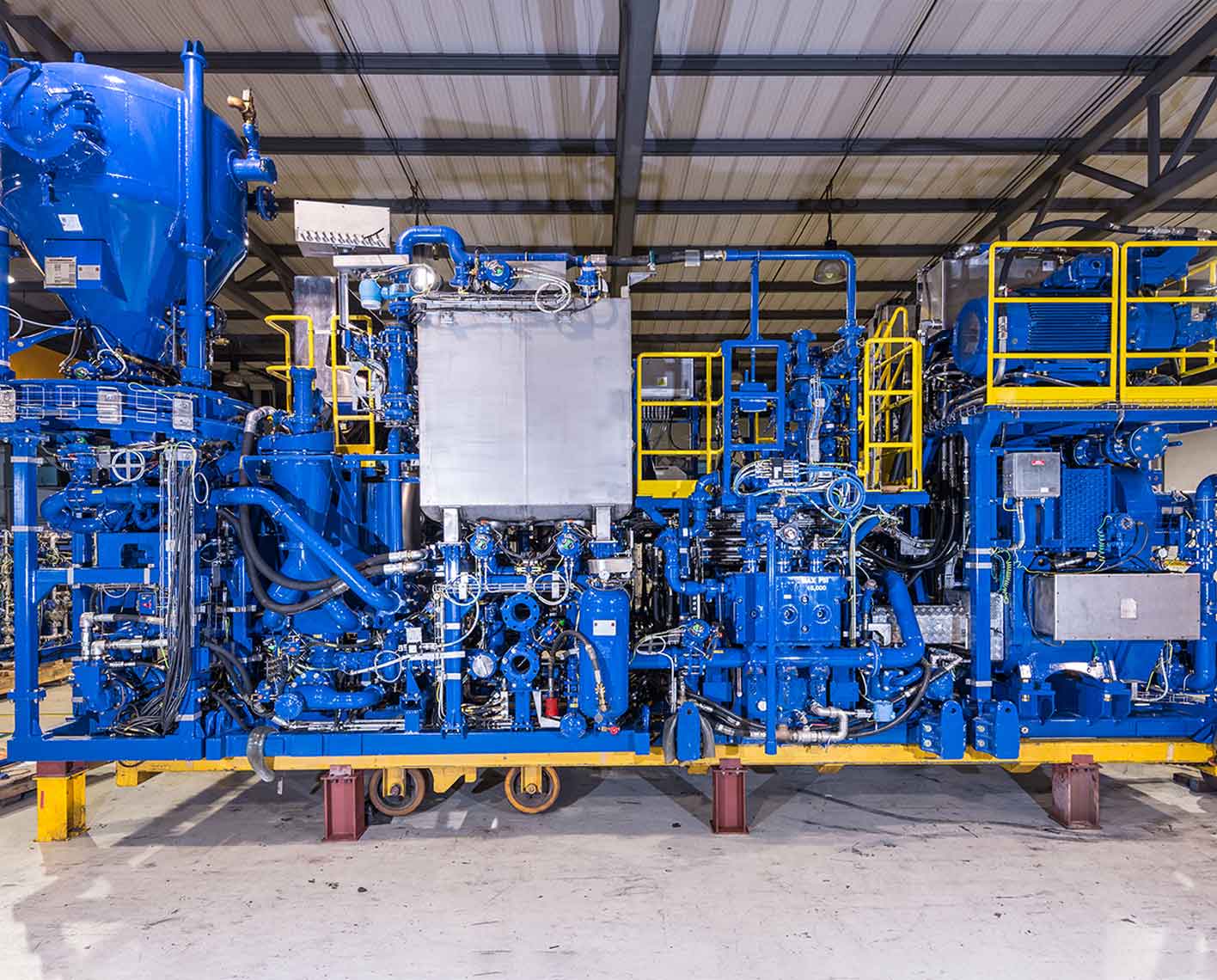 A completed CPS 730 cement pumping skid inside a manufacturing facility.