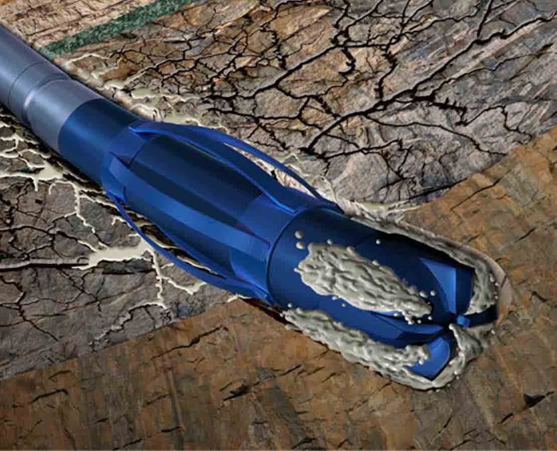 Blue drill bit with cementing fluid drilling into rock formation.