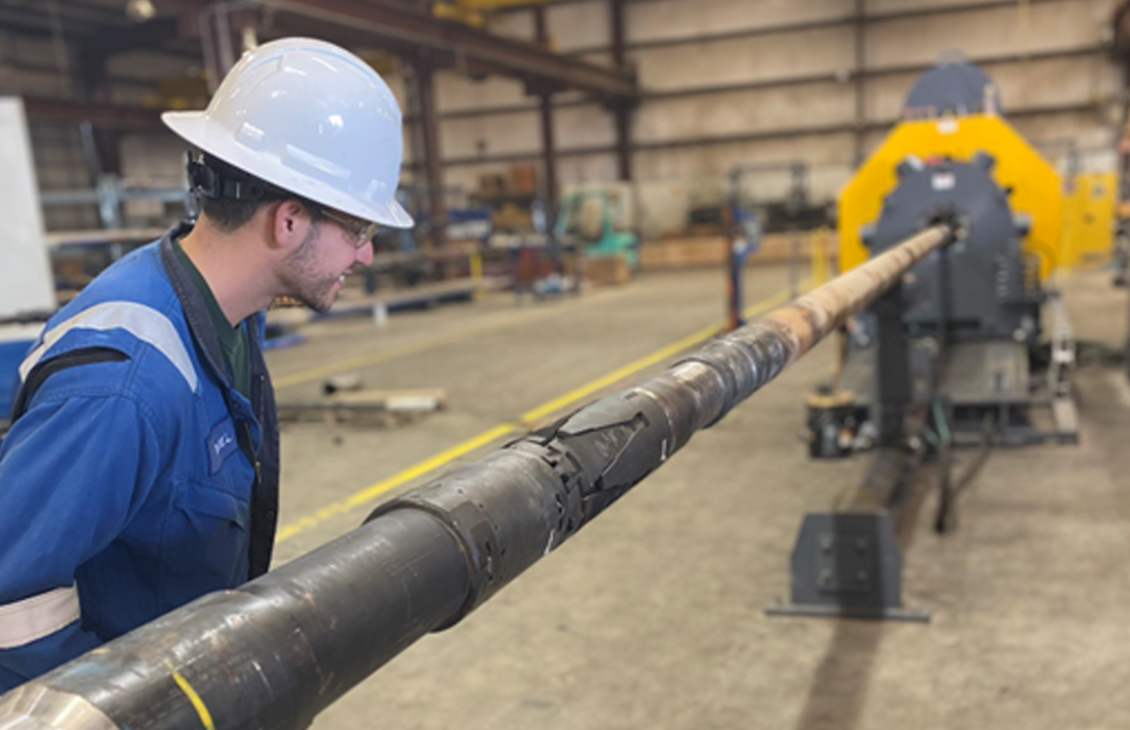 Photo of an SLB technician supervising testing of an Xcelis system at the base.