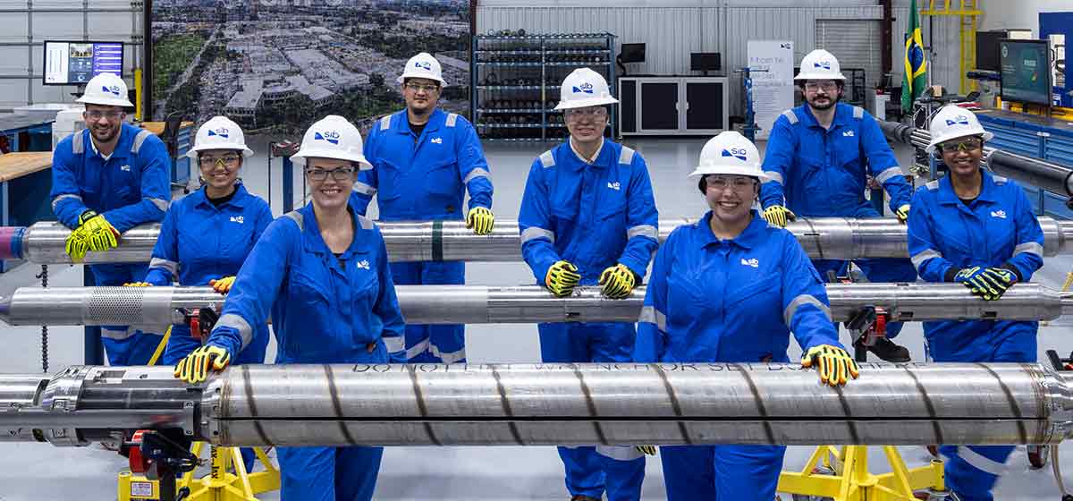 Photo of the team in a facility standing with the electric completions tools