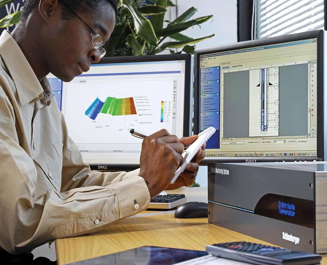 Schlumberger Worker Reviewing Distributed Measurement Systems Data