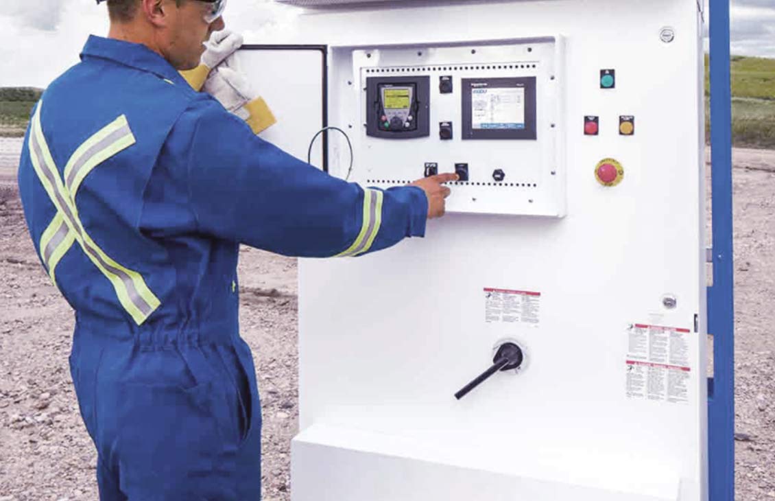 Schlumberger employees reads metering equipment in the field.