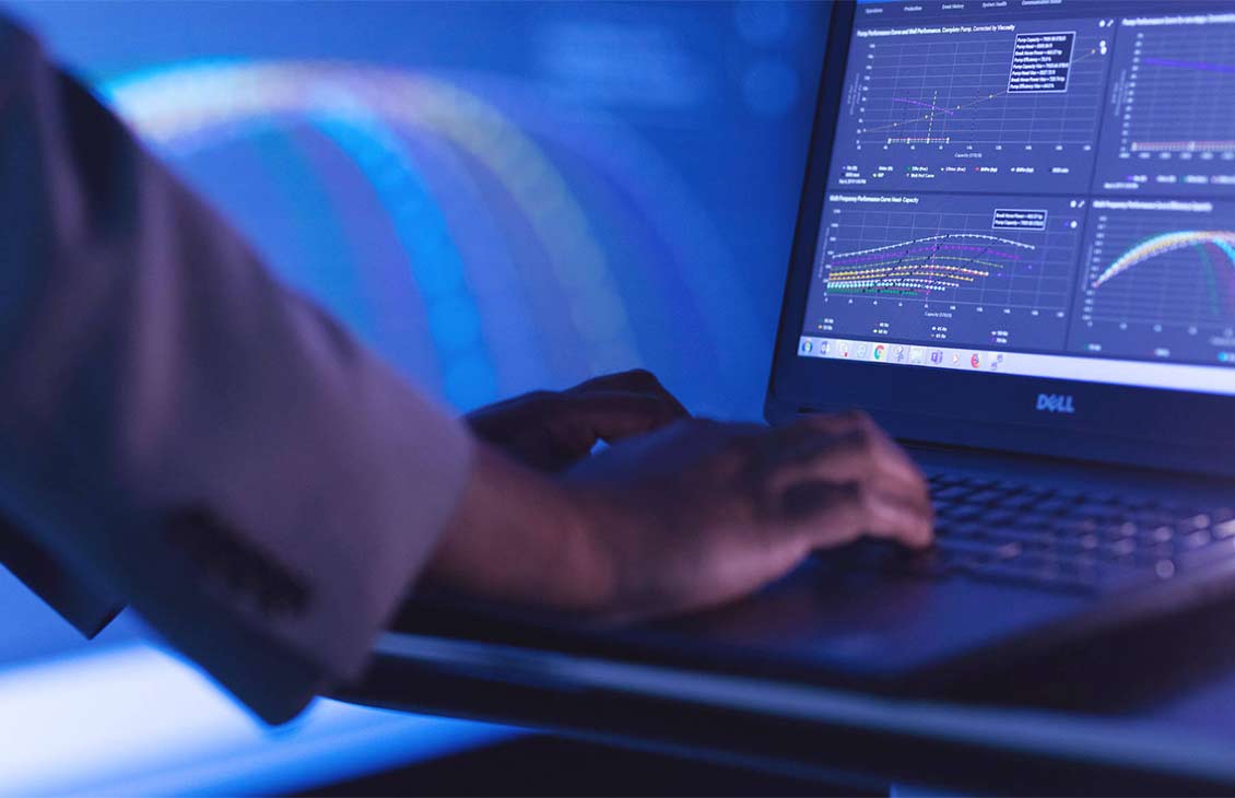 Man's hands on a computer interpreting data.