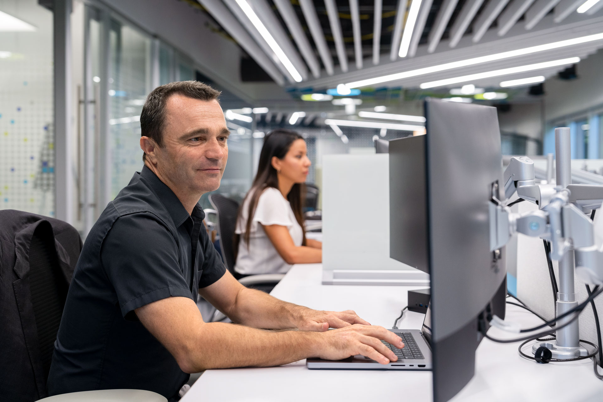 Man and woman at computer workstations - hero images