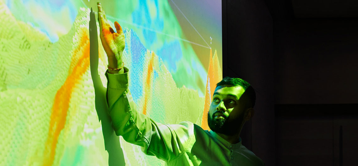 Person presenting on seismic data projected on a screen
