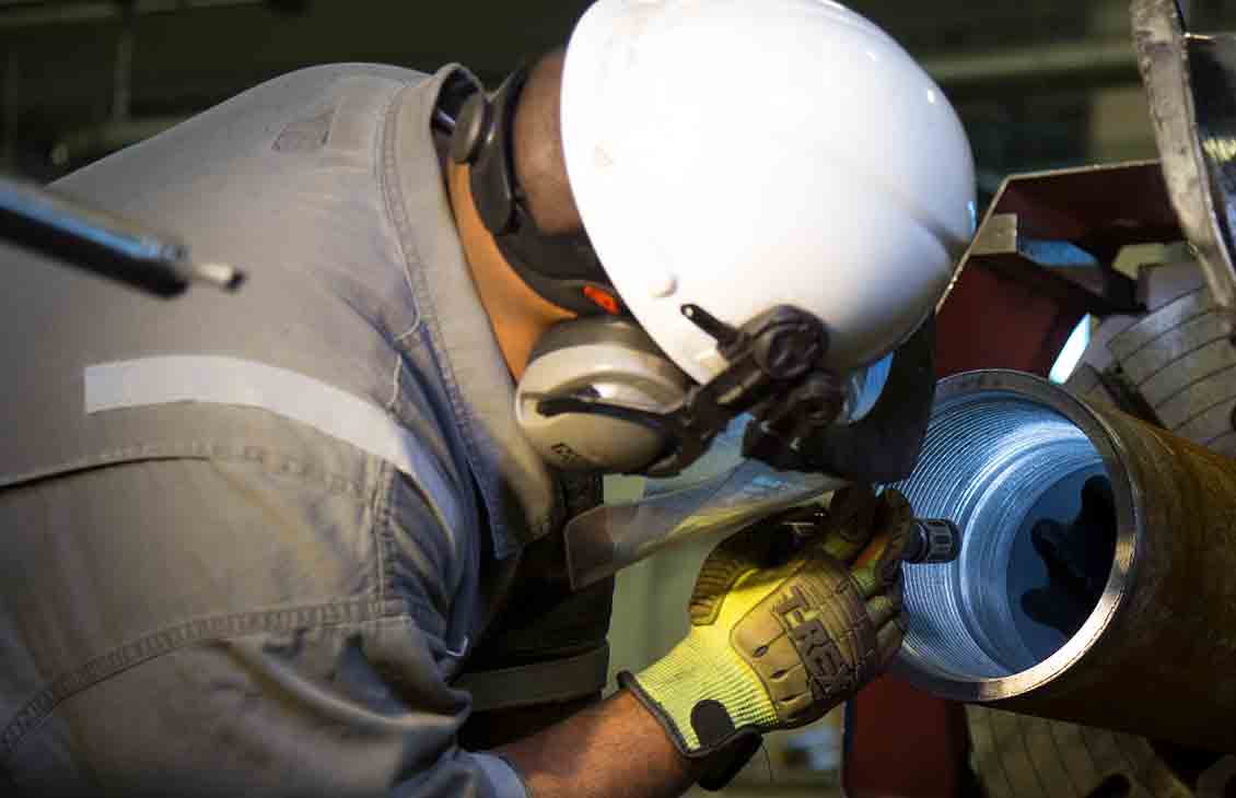 A manufacturing technician examines the completed elastomer of a TorqForce ruggedized steerable motor