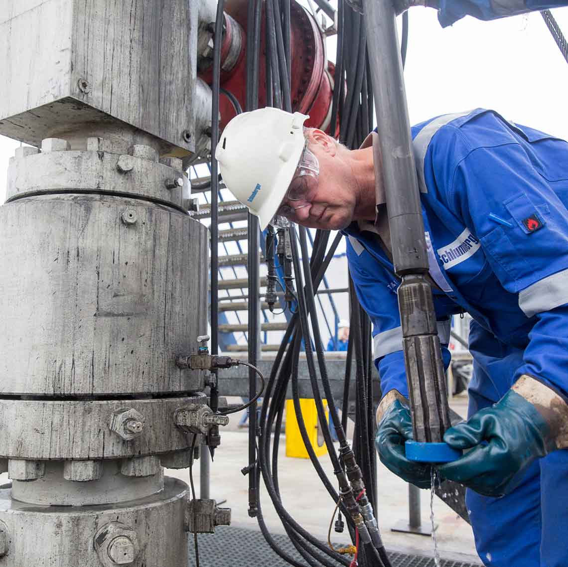 A technician examining a slimhole BHA just before it goes downhole