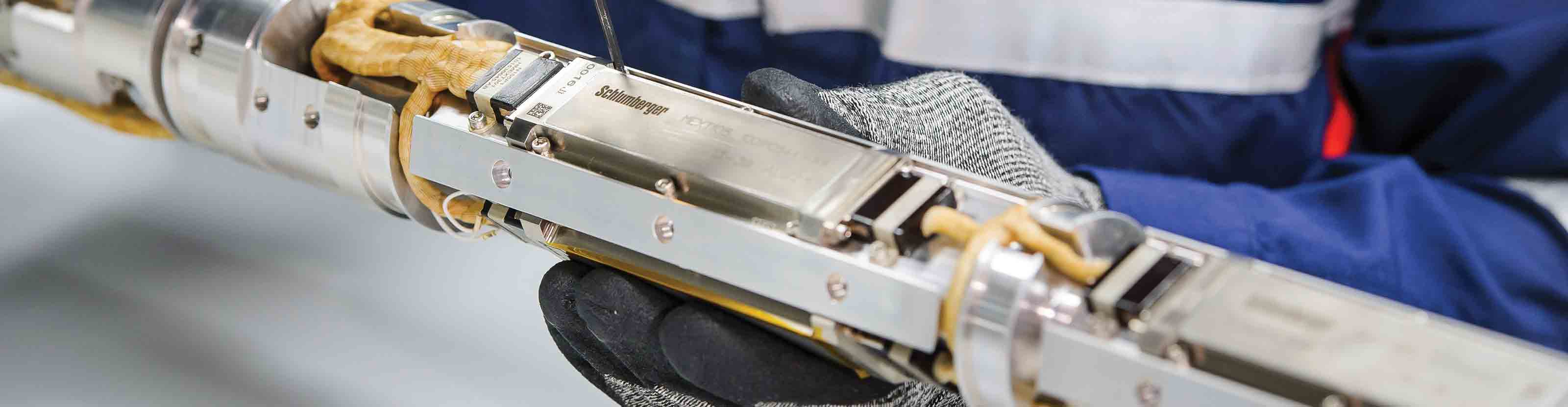 A Schlumberger technician working on the internal components of a PowerDrive ICE RSS