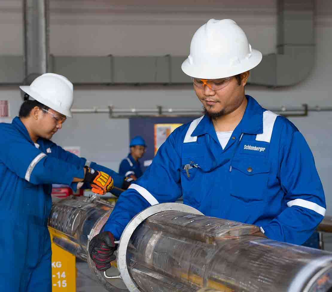 Technicians in Indonesia make adjustments to an adnVISION Azimuthal Density Neutron Service tool
