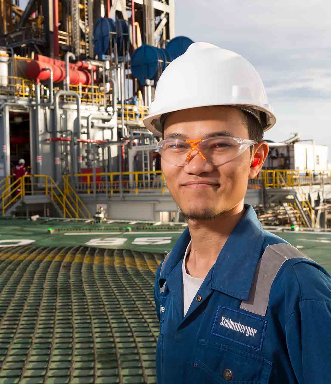 Man standing on deck of an offshore oil rig.