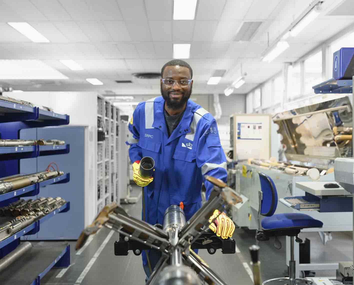 Photo of man working on a downhole logging tool