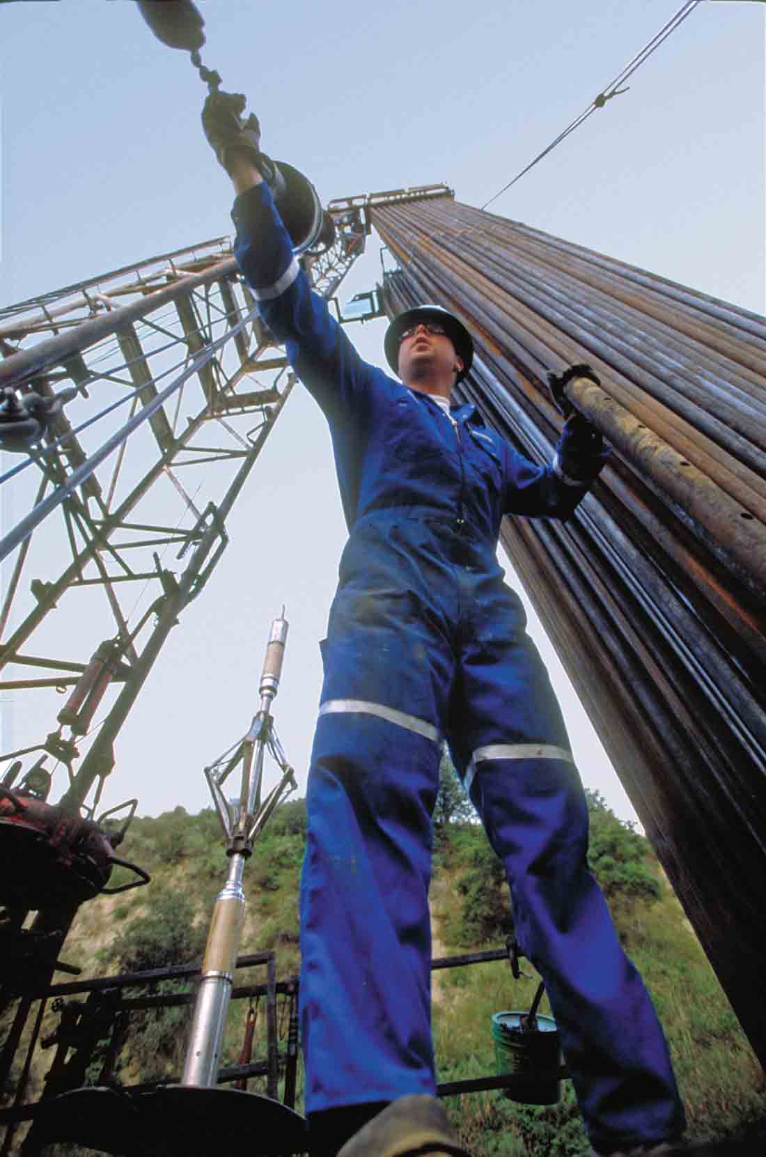 A Schlumberger employee preparing the PowerCutter to be lowered in a well.