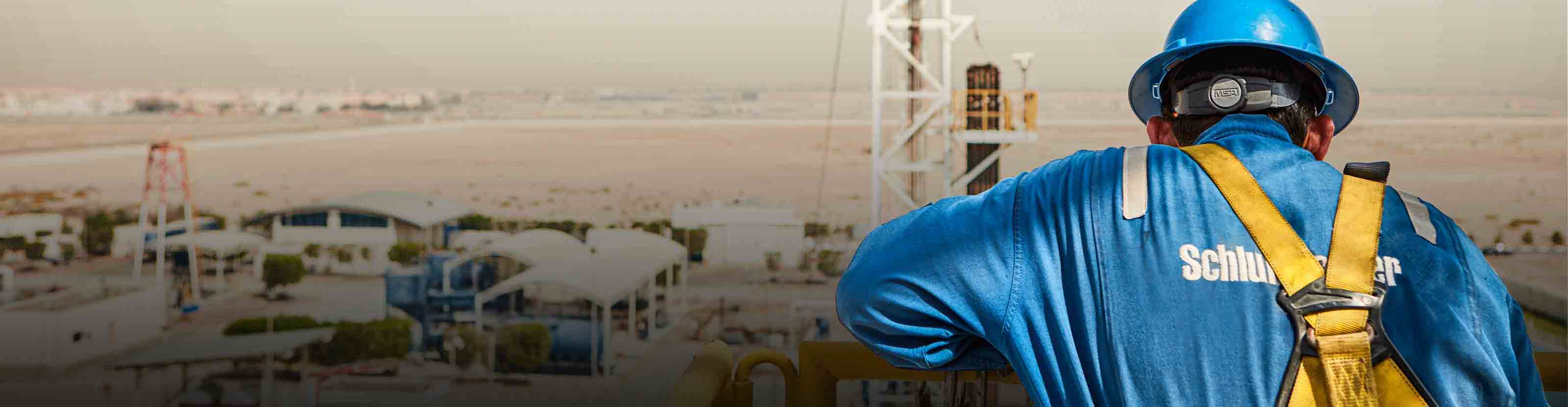 Person in PPE looking over rig site.