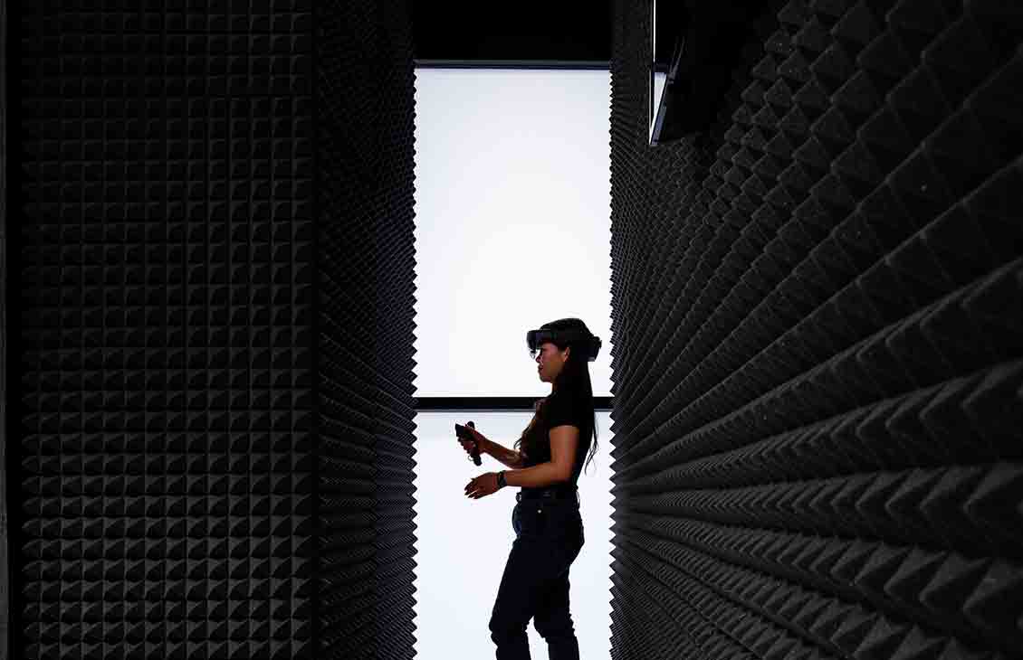 Woman exploring in VR headset at an office facility (Tier 1_Office_Houston_AML_4962)