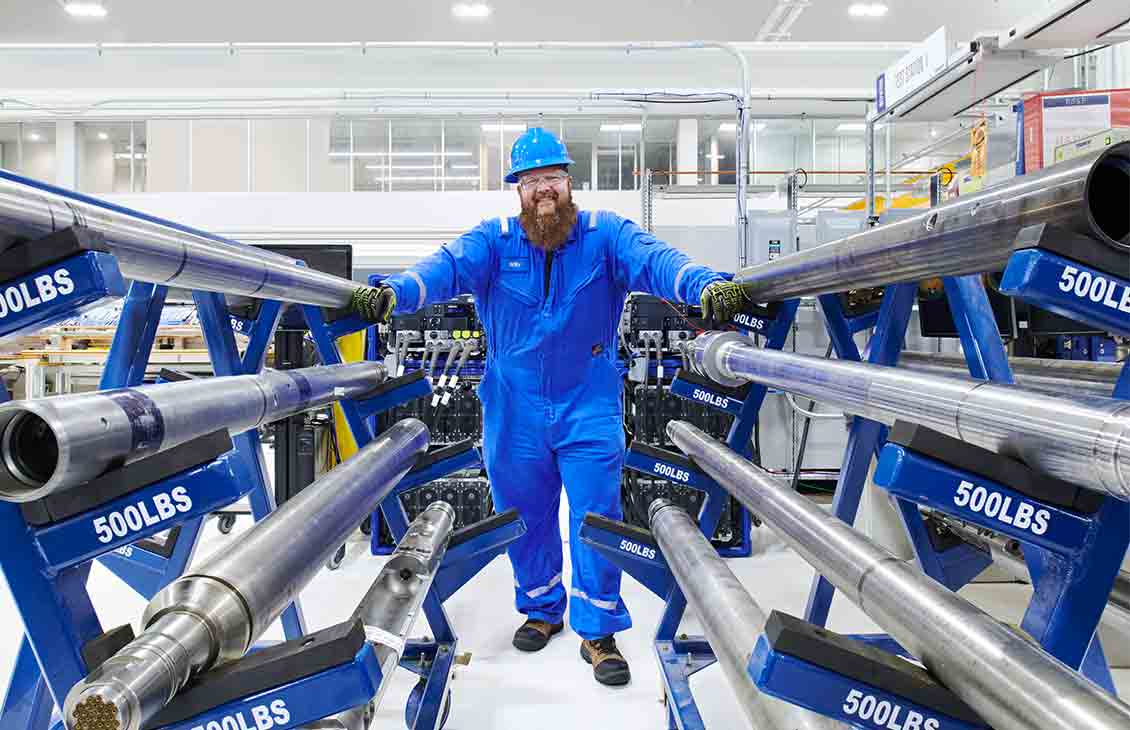 Man standing with equipment at manufacturing facility (Tier 1_ManufacturingFacility_Sugar Land_AML_5413)