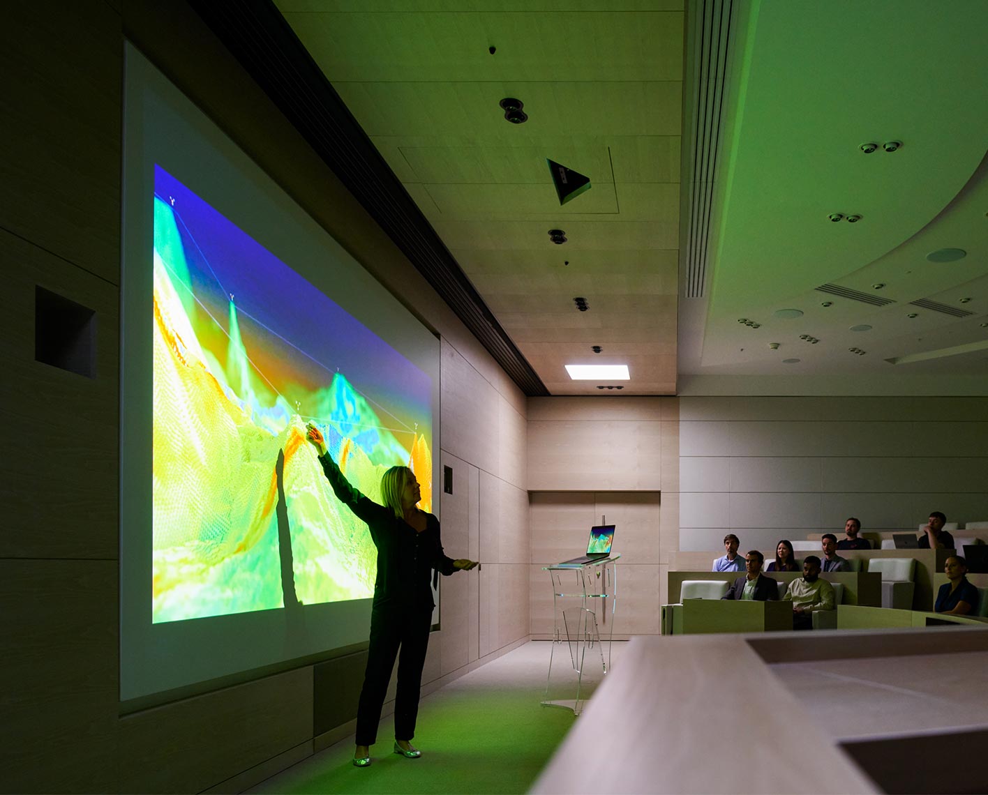 Woman giving a presentation to a crowd in an auditorium