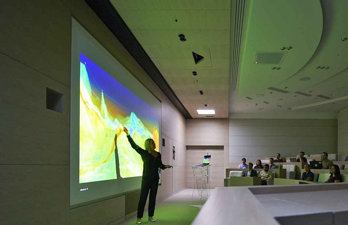 Woman presenting subsurface model in front of class