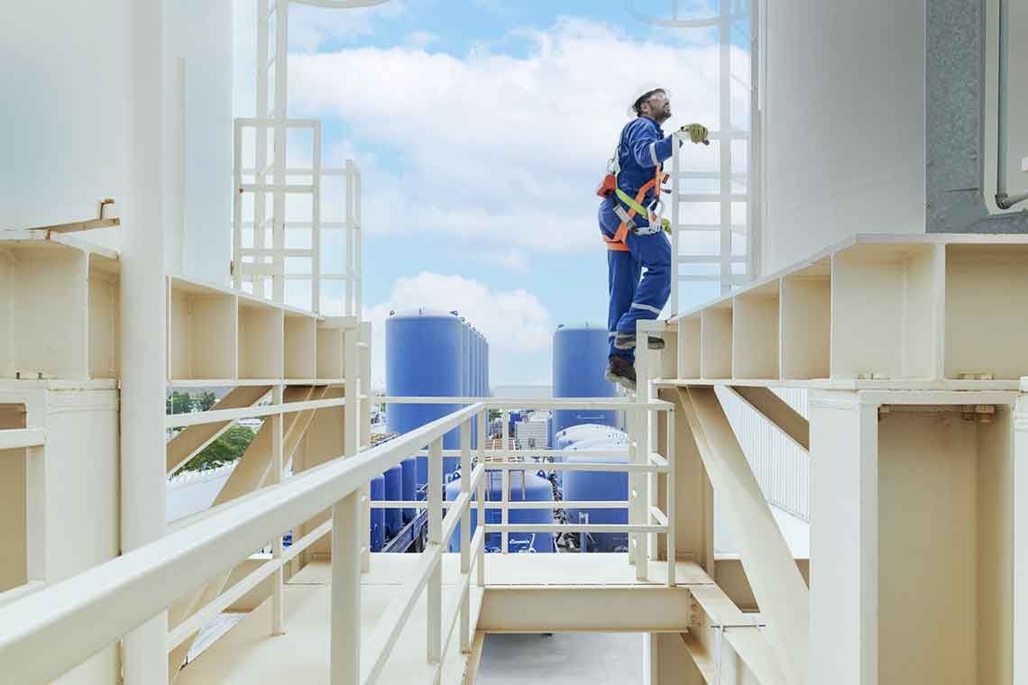 SLB engineer climbing a ladder